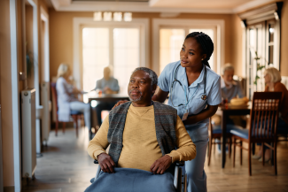 Nurse helping resident with wheelchair 
