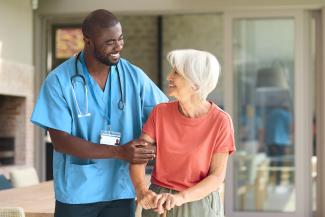 Nurse helping a nursing home resident walk